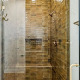 Modern shower with brown tiled walls